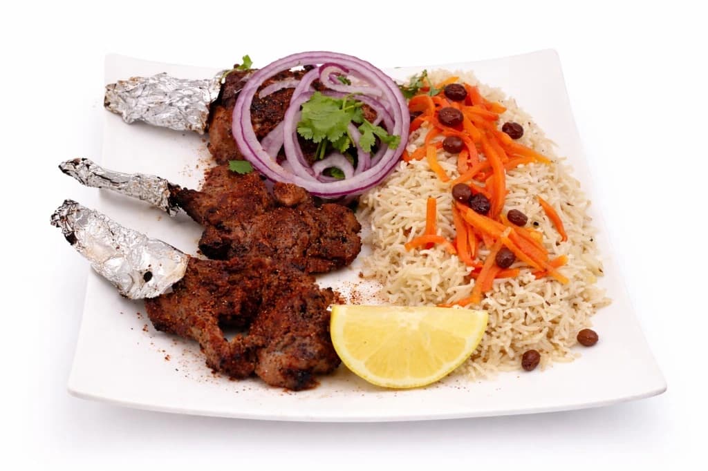Authentic Afghan Chopan Kebob — Traditional grilled rib kebob served with rice, bread, chick...
